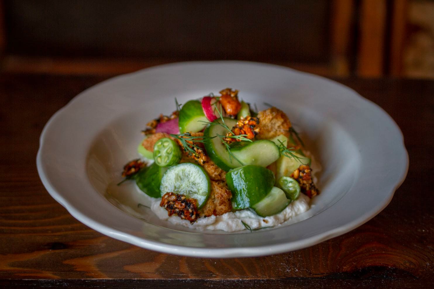 Close up of Cucmber Salad served with whipped feta cashew granola.